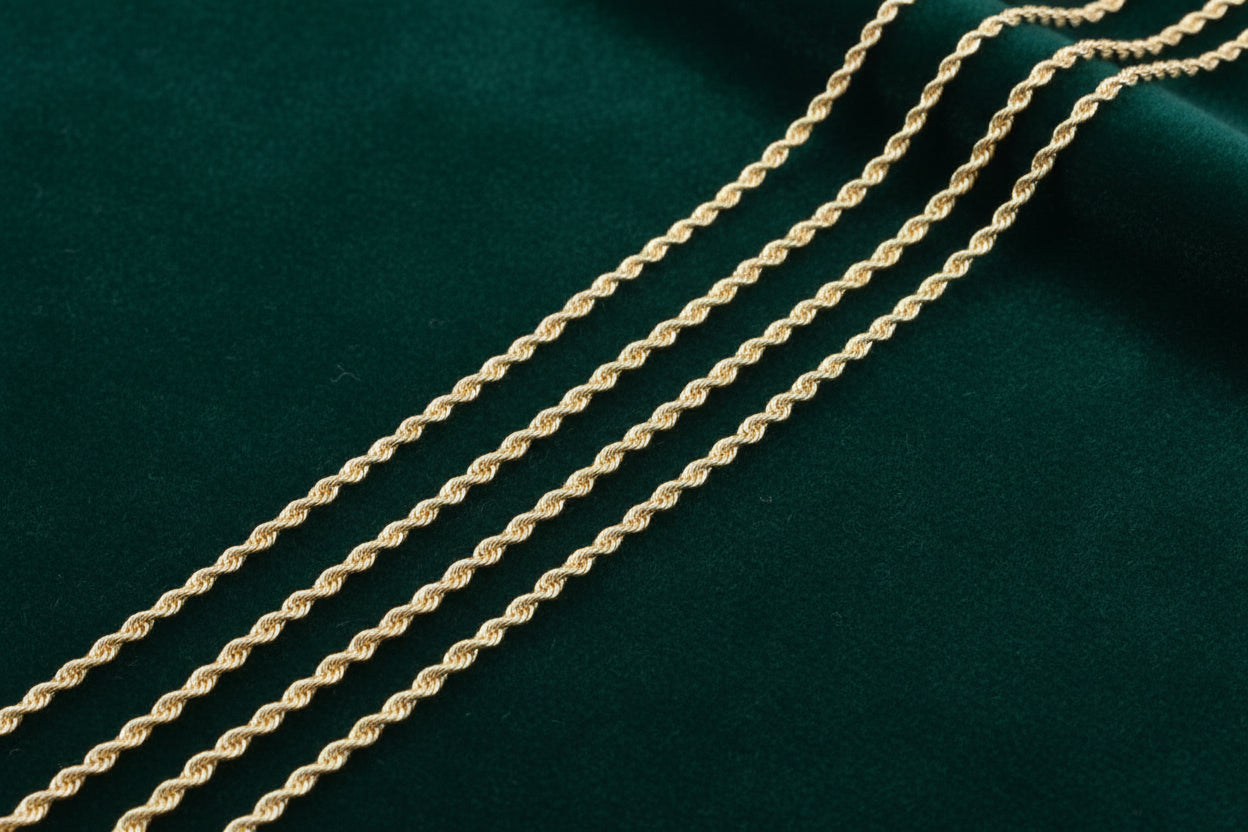 Gold rope chain on a dark green fabric background