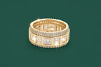 Gold ring with embedded diamonds on a green background