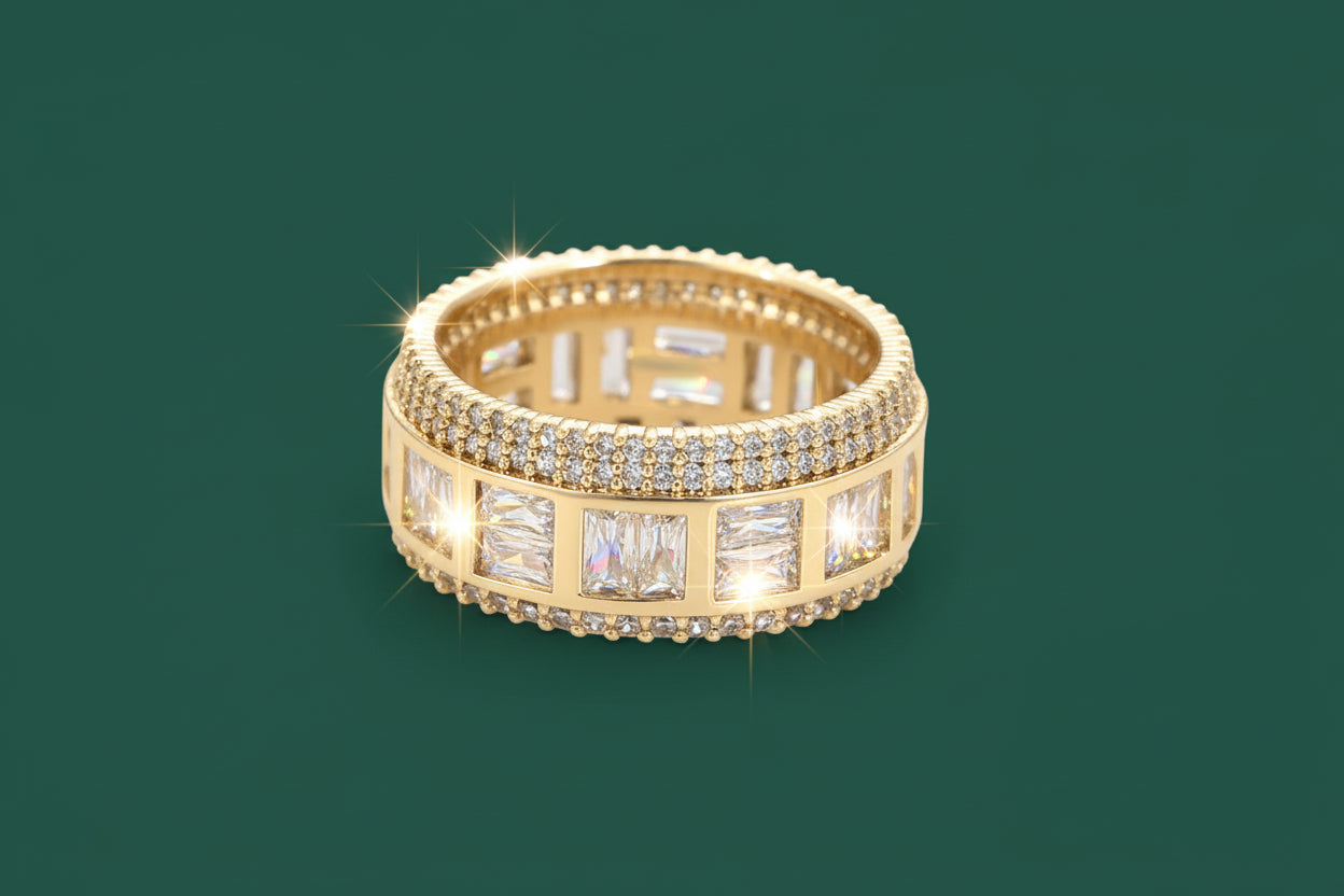 Gold ring with embedded diamonds on a green background