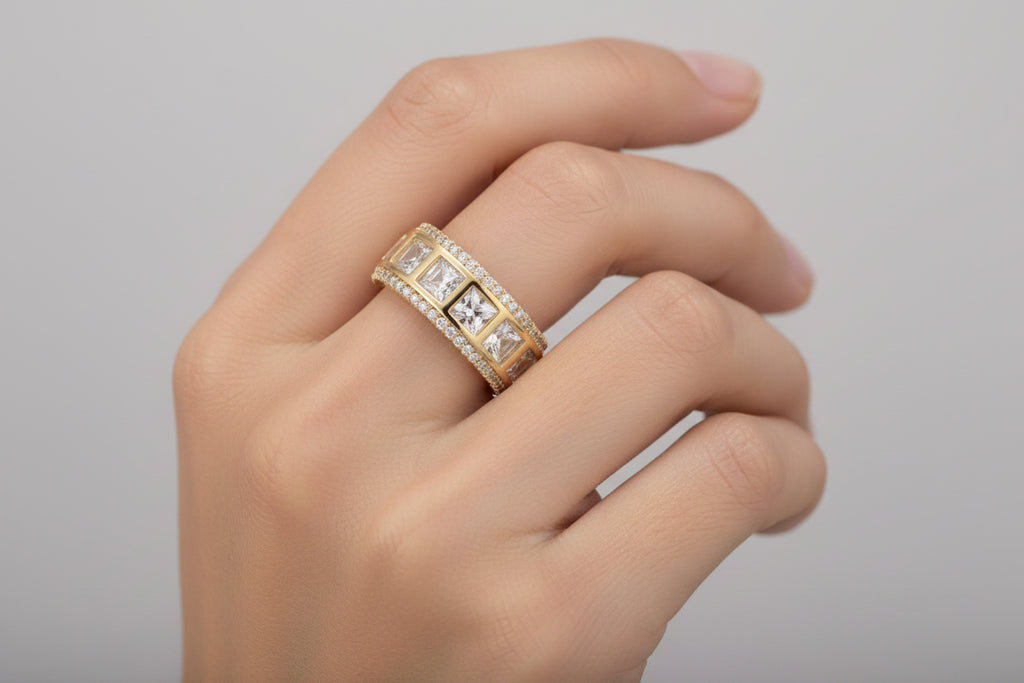 Gold ring with diamond accents on a light gray background