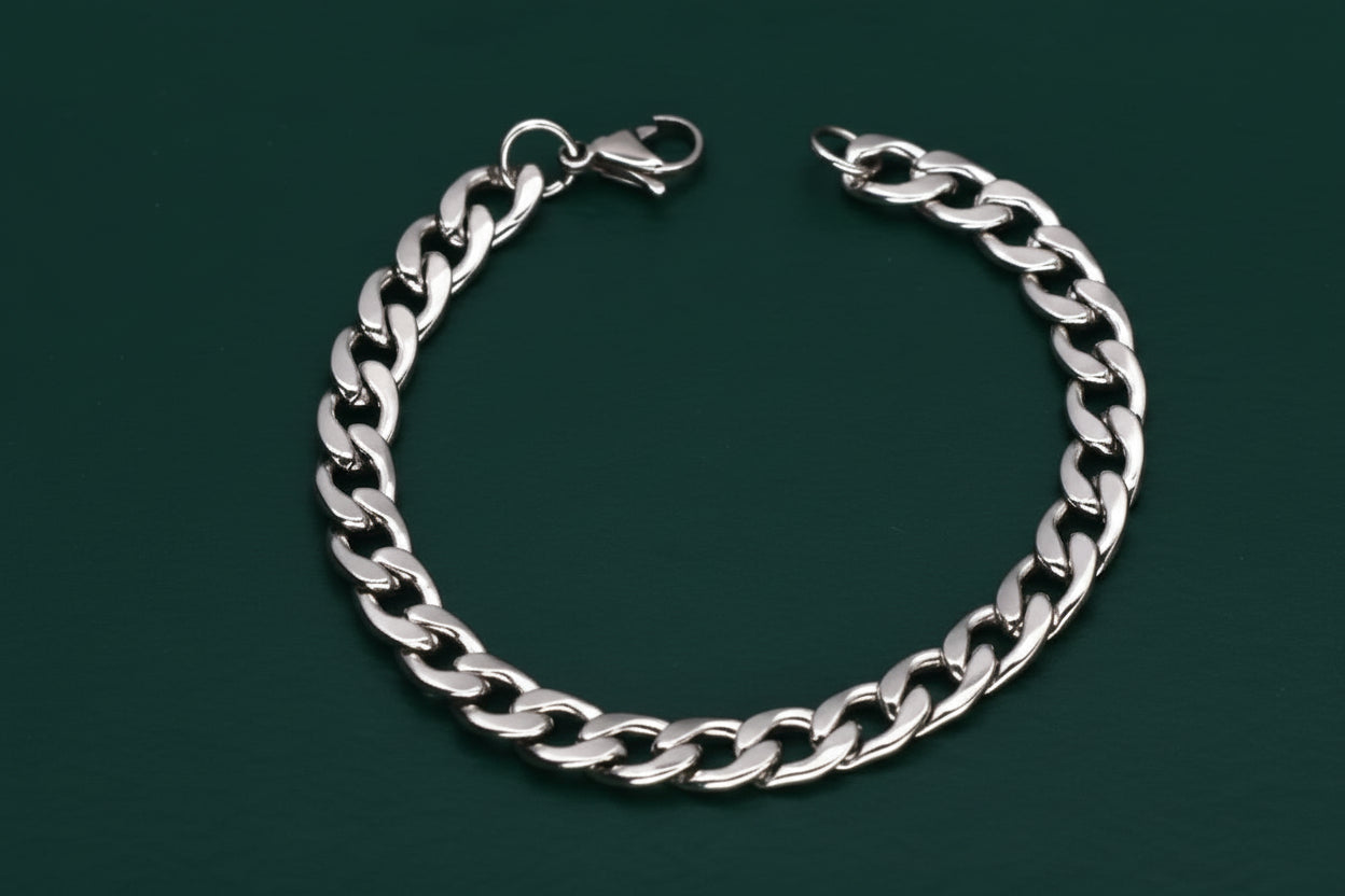 Silver chain bracelet on a dark green background