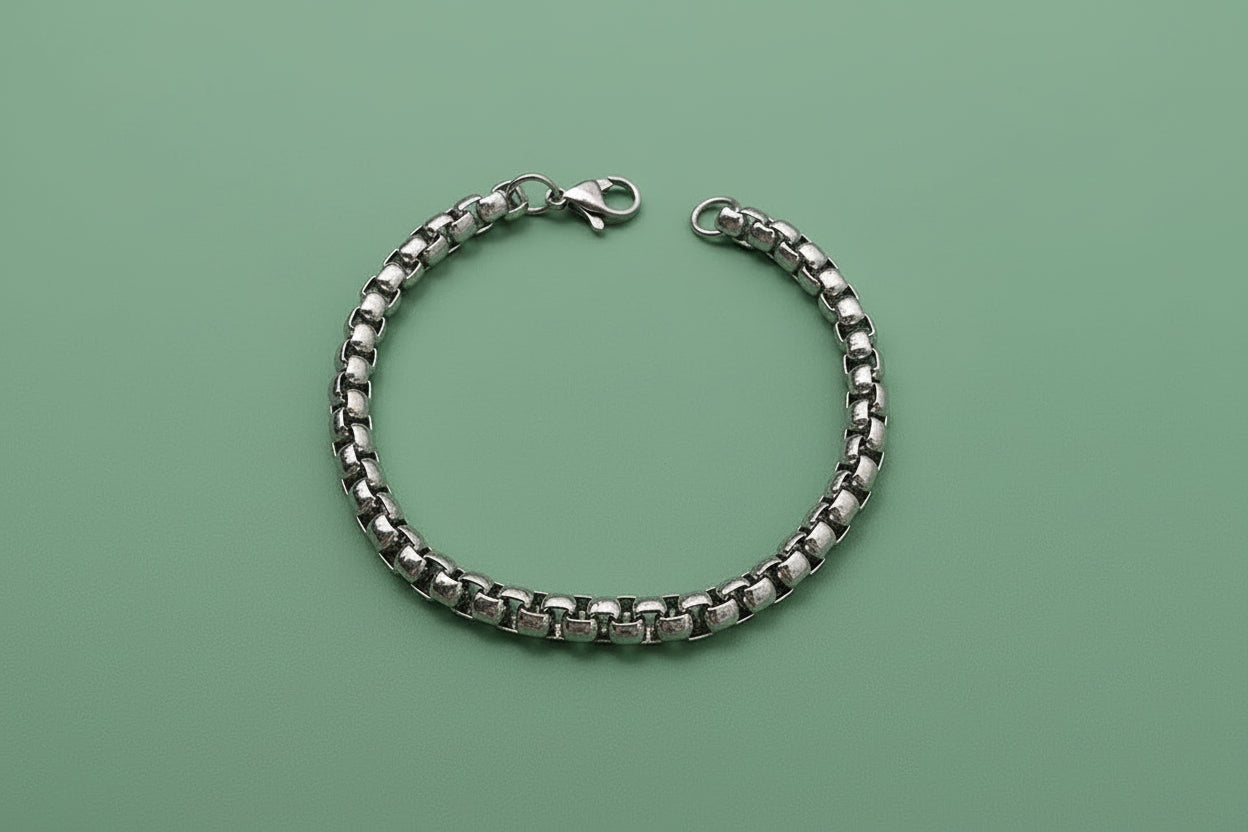 Silver square pearl chain bracelet on a textured surface