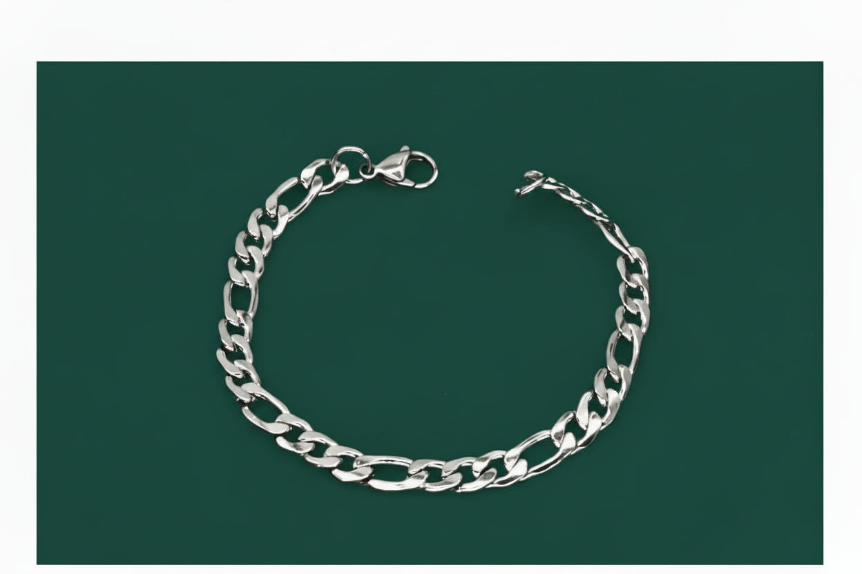 Silver chain bracelet on a green background