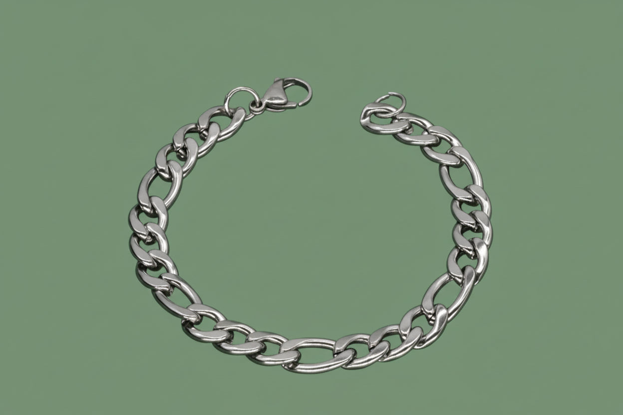 Silver chain bracelet on a green background