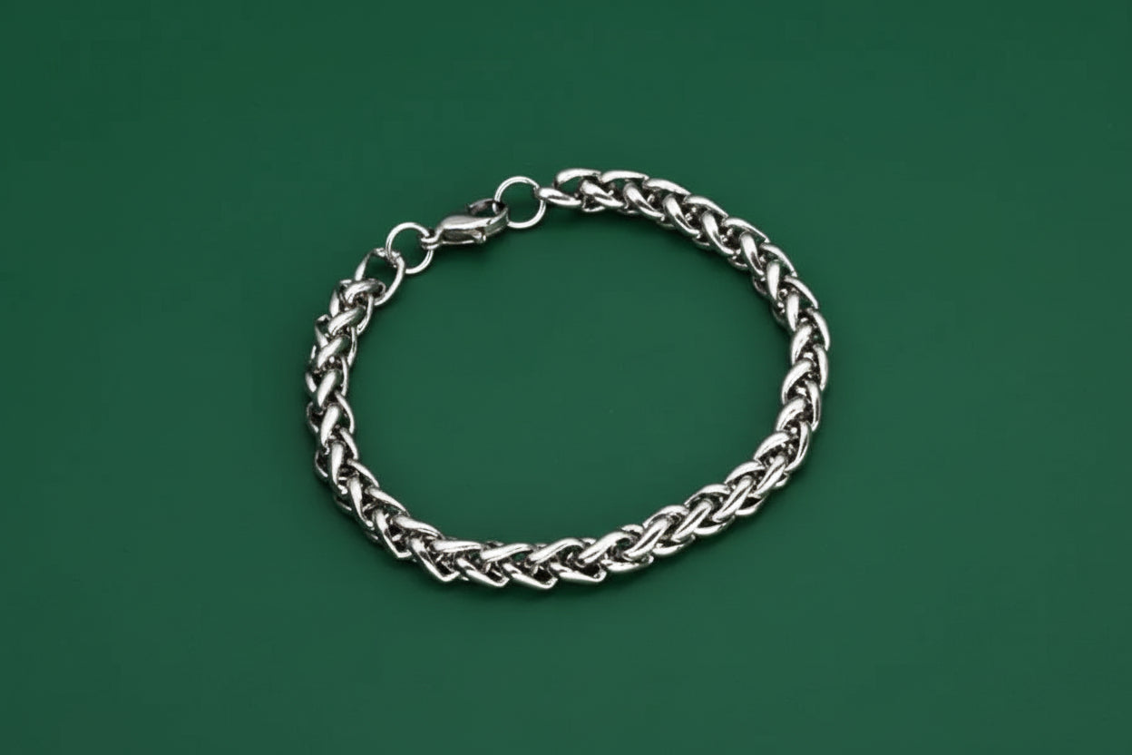Silver chain bracelet on a green background