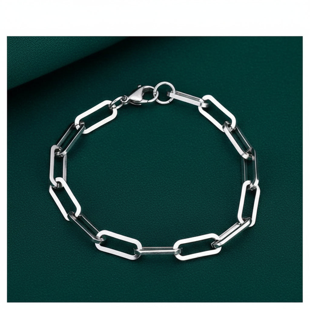 Silver chain bracelet on a dark green background