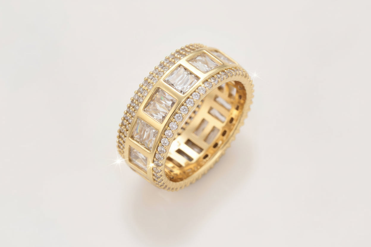 Gold ring with diamond accents on a light gray background