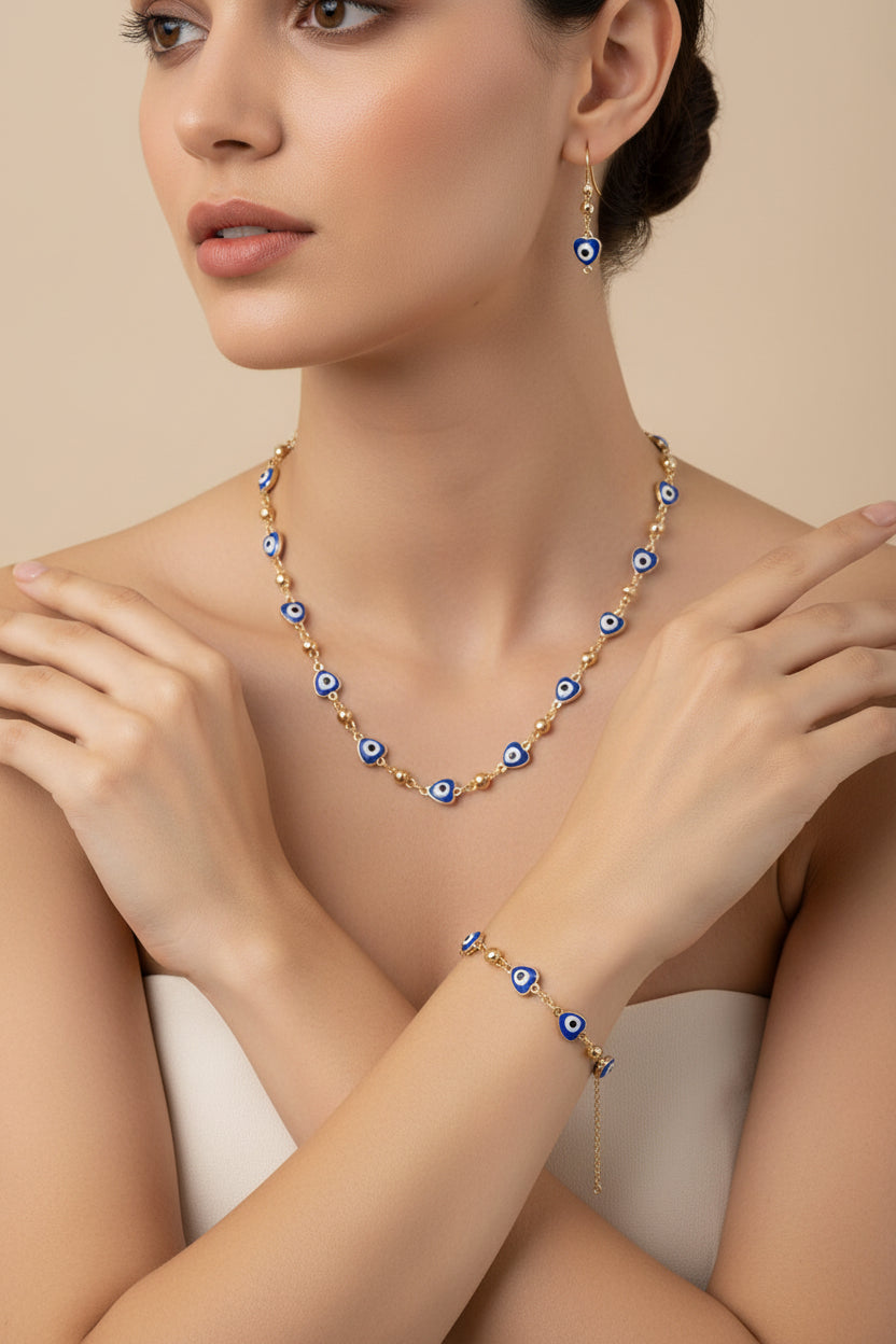 Necklace and earrings with blue and white eye design on a wooden stand.