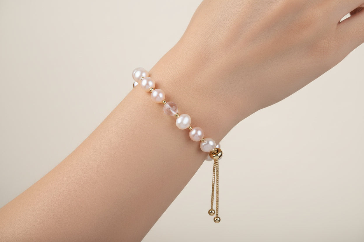 Pearl bracelet with gold accents on a white background