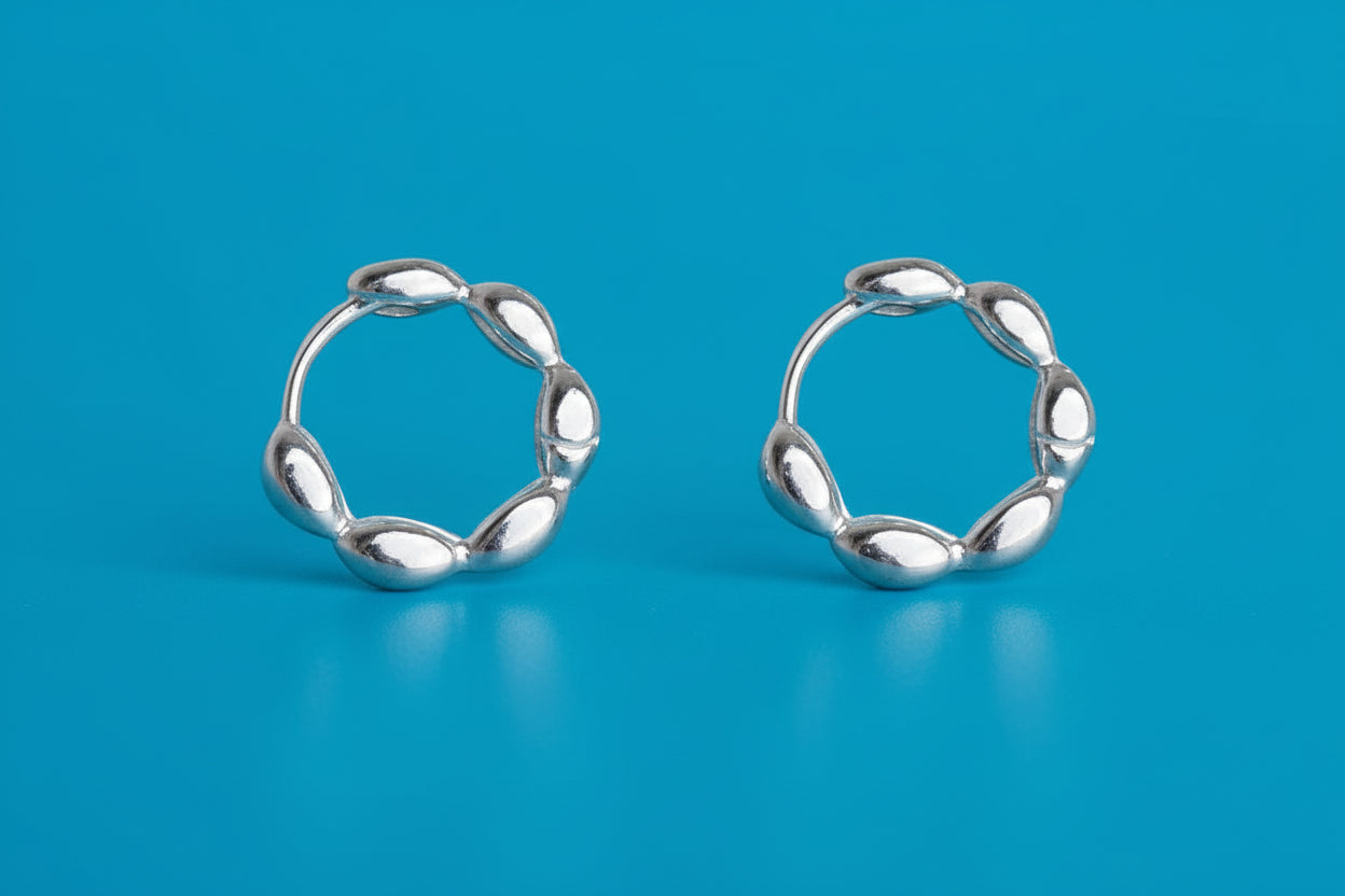 Pair of silver hoop earrings on a white background