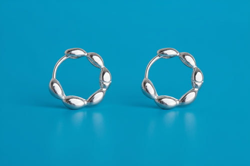 Pair of silver hoop earrings on a white background