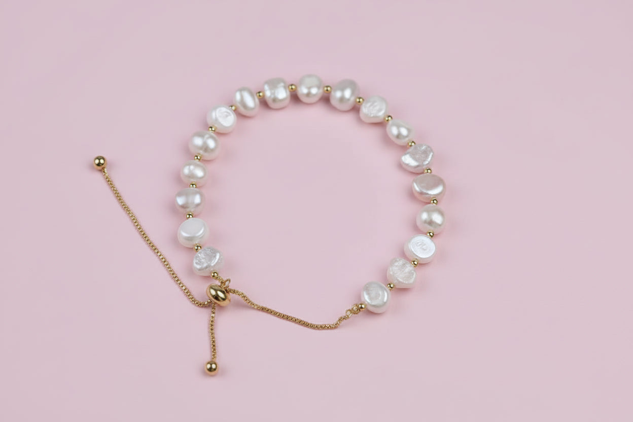 Pearl bracelet with gold accents on a white background