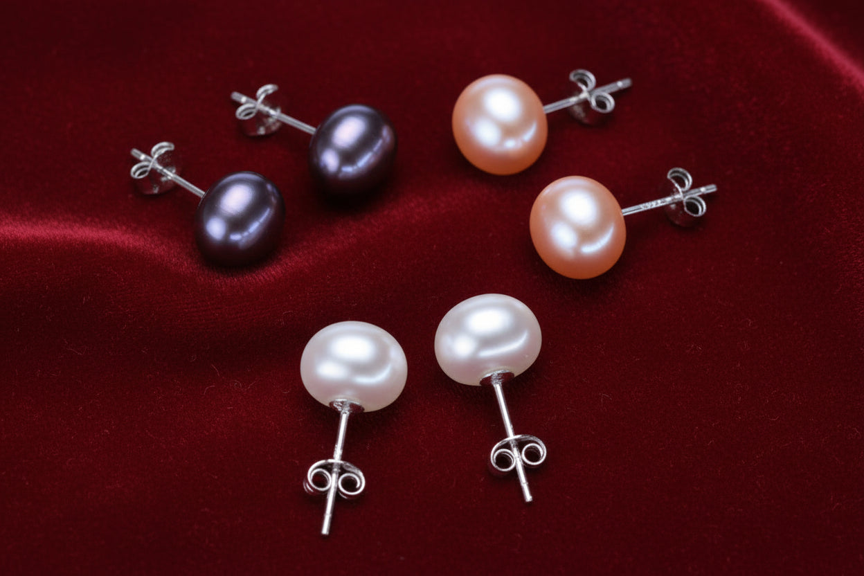 Set of pearl earrings in various colors on a white background