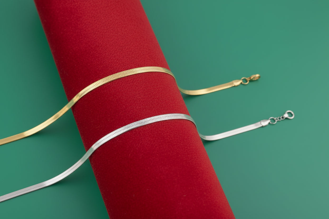 Gold and silver snake chain necklaces on a white background