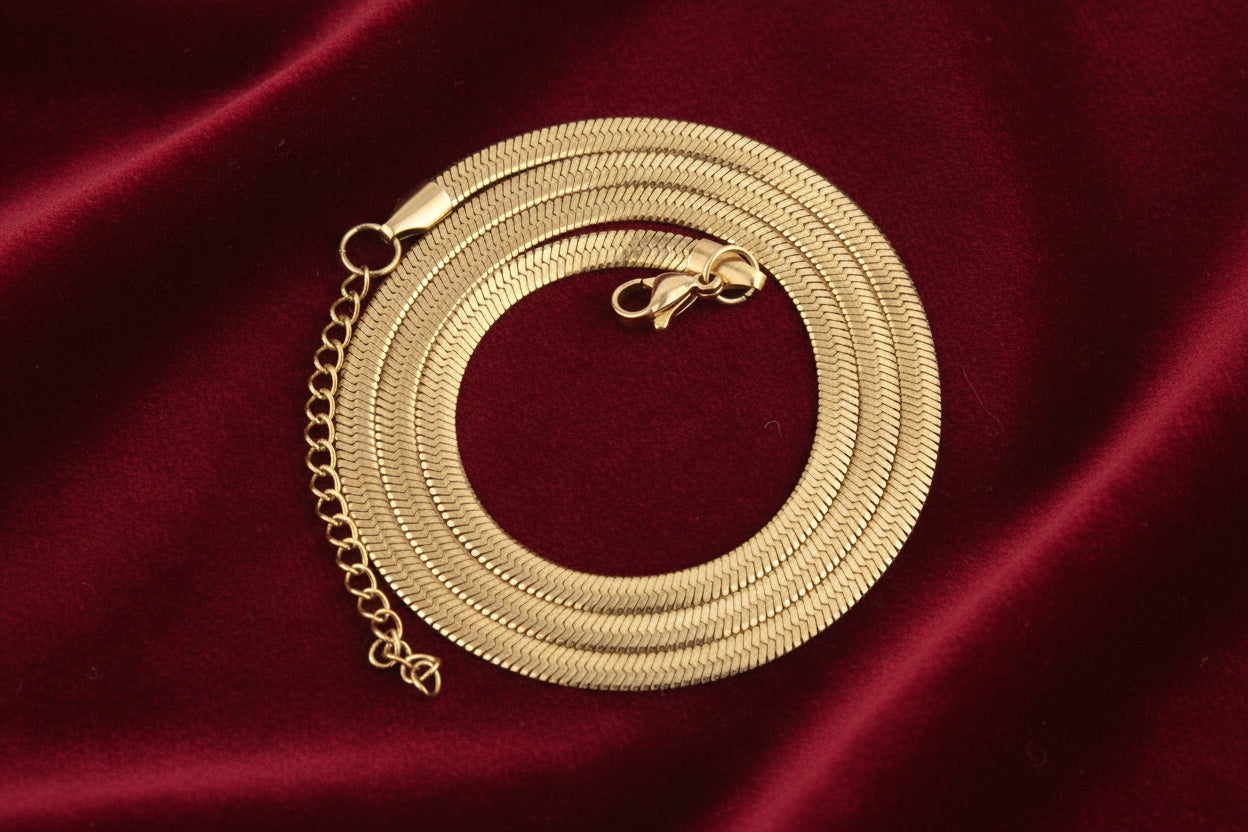 Gold chain necklace on a white background