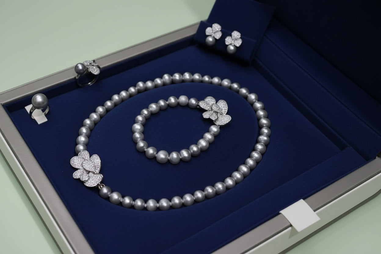 Pearl necklace, bracelet, and earrings set on a white surface