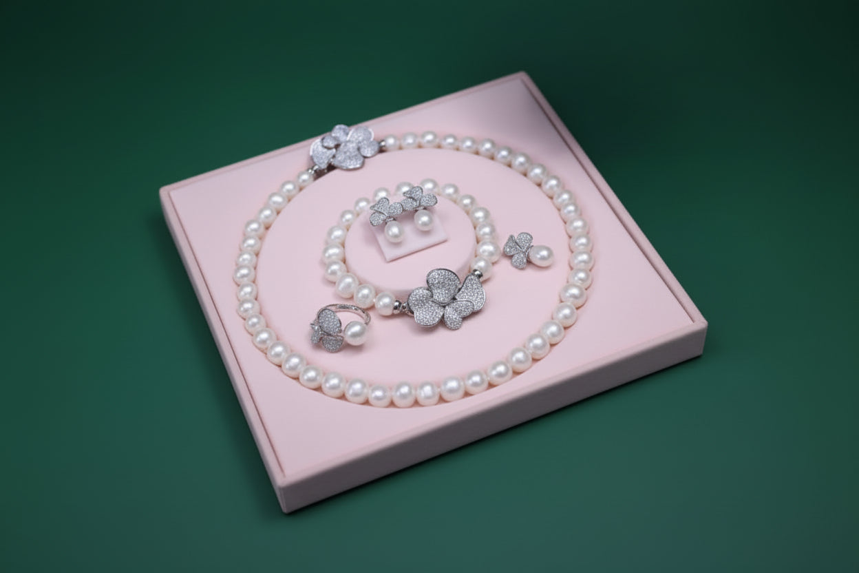 Pearl jewelry set with silver floral designs on a heart-shaped box