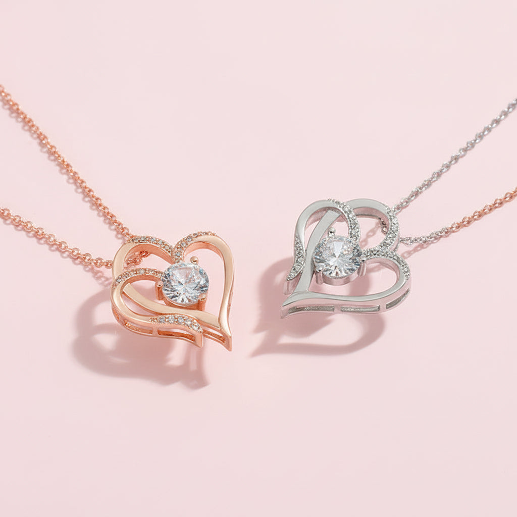 Two heart-shaped pendants, one rose gold and one silver, on white background