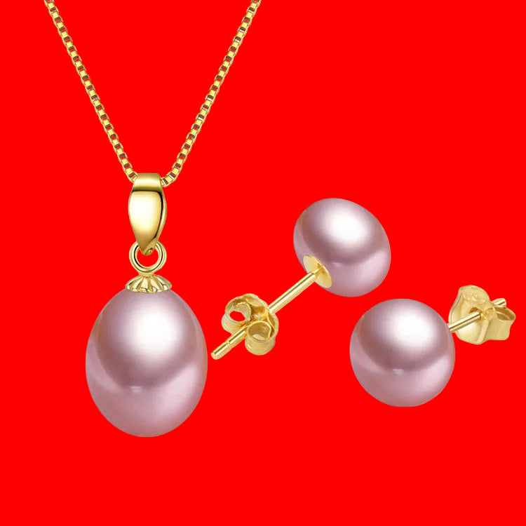 Pearl necklace and earrings set with gold clasps on a white background