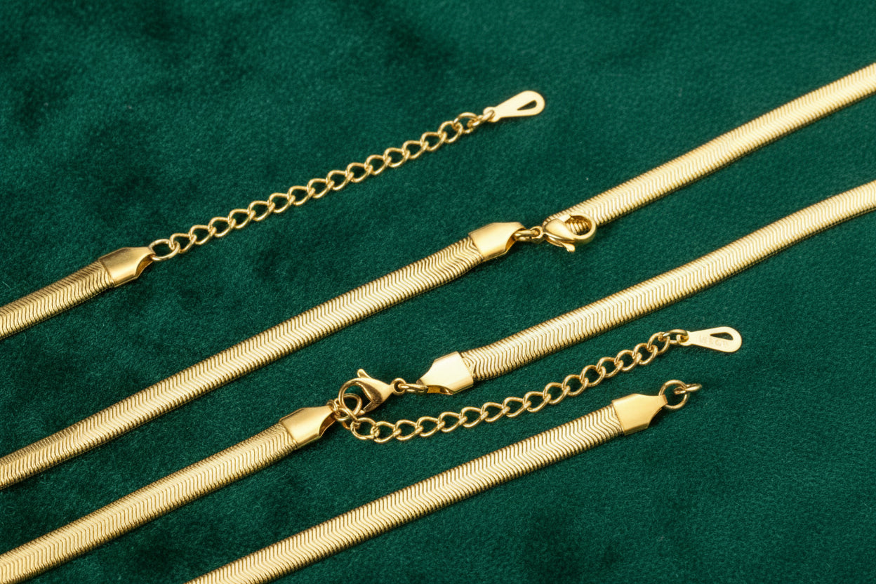 Set of gold necklaces on a white background