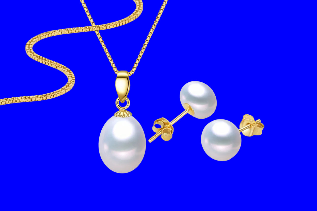 Pearl necklace and earrings set with gold accents on a white background, featuring the Integrity Pearl brand.